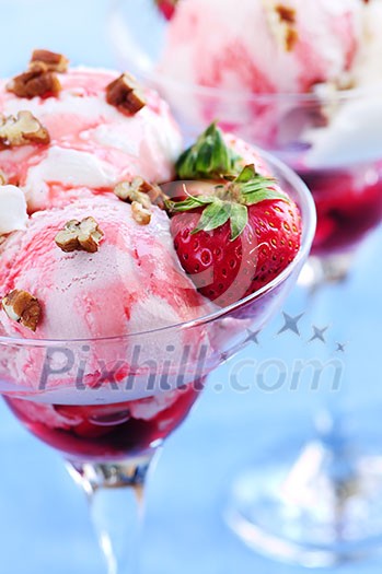 Strawberry ice cream sundae with fresh strawberries and walnuts