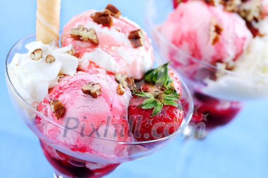 Strawberry ice cream sundae with fresh strawberries and walnuts