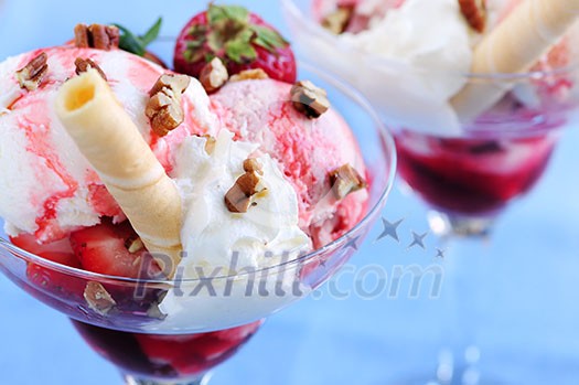 Strawberry ice cream sundae with fresh strawberries and walnuts