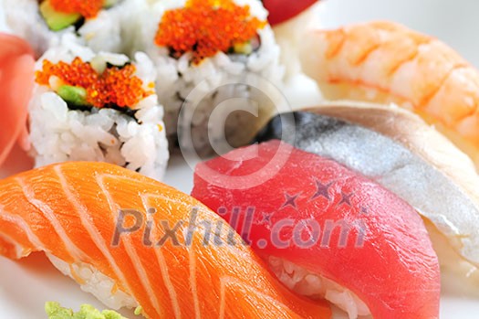 Sushi and california rolls on a plate macro Sushi and california rolls on a plate macro