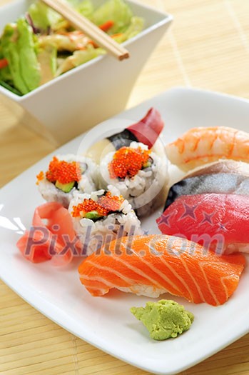 Lunch of assorted sushi and green salad Lunch of assorted sushi and green salad