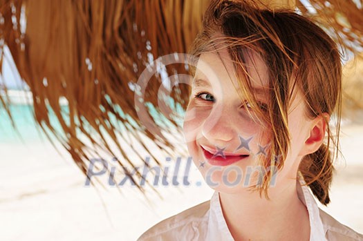 Portrait of a young girl on tropical beach under umbrella Portrait of a young girl on tropical beach under umbrella