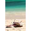 Flipflops on a sandy ocean beach - vacation concept