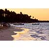 Sandy beach of a tropical resort at sunset