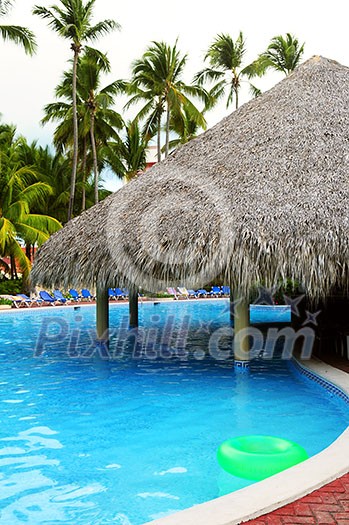 Swimming pool with swim up bar at tropical resort Swimming pool with swim up bar at tropical resort