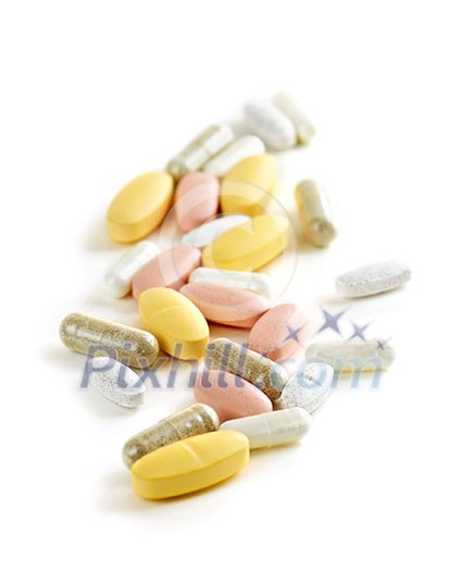 Mix of vitamins and herbal supplements on white background Mix of vitamins and herbal supplements on white background
