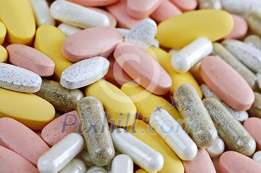 Mix of vitamins and herbal supplements close up Mix of vitamins and herbal supplements close up