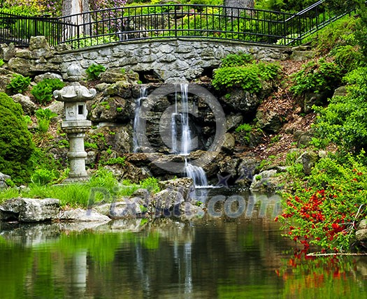 Cascading waterfall and pond in japanese garden