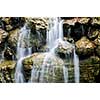 Waterfall over natural stones in japanese zen garden