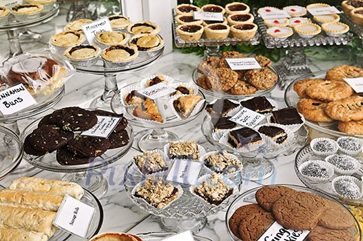 Various desserts on display in bakery window Various desserts on display in bakery window