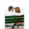 Mature romantic couple on a bench on seashore