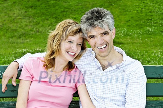 Portrait of mature romantic couple on a bench