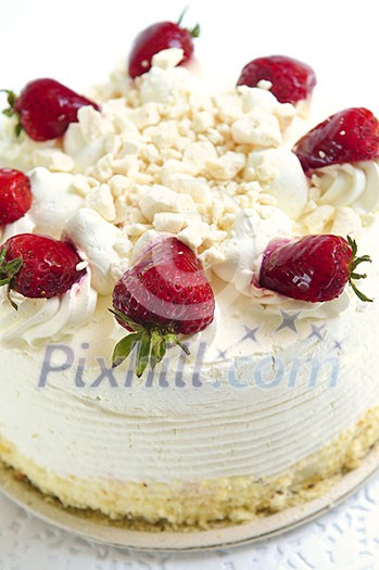 Whole strawberry meringue cake on white background