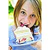 Teenage girl eating a piece of strawberry cake