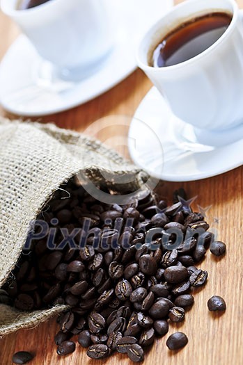 Spilled coffee beans and cups of espresso Spilled coffee beans and cups of espresso