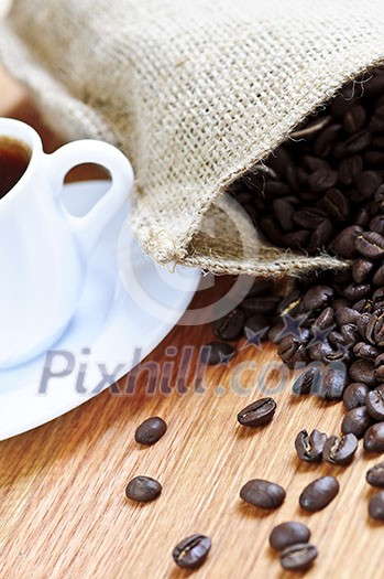 Spilled coffee beans and cups of espresso Spilled coffee beans and cups of espresso