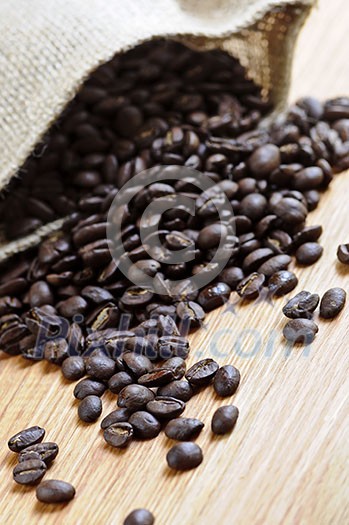 Roasted coffee beans in a rustic canvas bag Roasted coffee beans in a rustic canvas bag