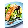 Green salad with grilled salmon fillet and lemon