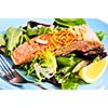 Green salad with grilled salmon fillet and lemon