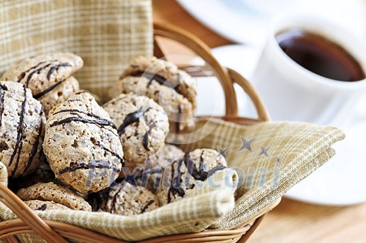 Fresh sandwich cookies in a basket and espresso coffee