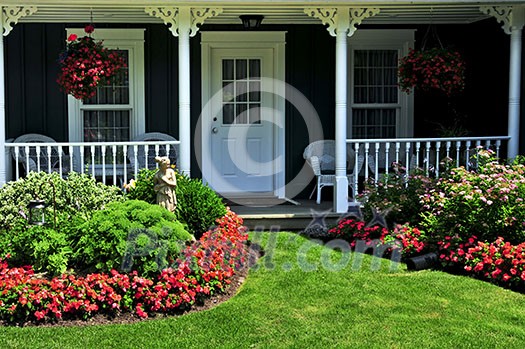 Landscaped front yard of a house with flowers and green lawn Landscaped front yard of a house with flowers and green lawn