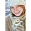 Teenage girl in winter hat with cup of hot chocolate