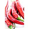 Bunch of red hot chili peppers on white background close up