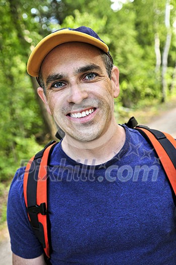 Portrait of happy middle aged man on a forest trail Portrait of happy middle aged man on a forest trail