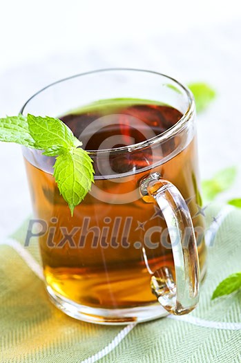 Cup of fresh herbal mint tea with peppermint leaves