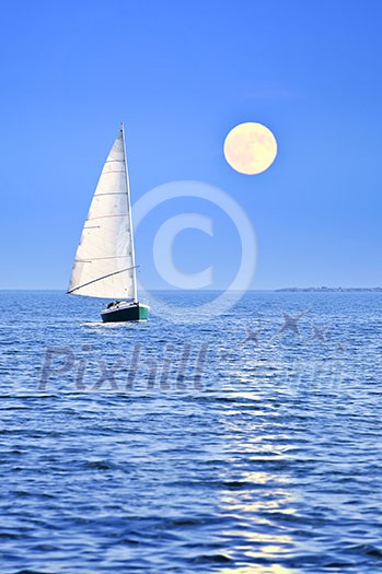 Sailboat sailing in a sea at full moon night