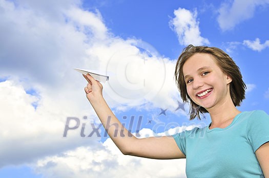 Young teenage girl holding a paper airplane