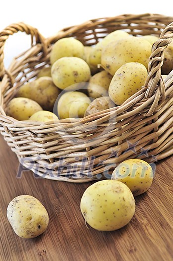 Yellow raw potatoes in a basket close up Yellow raw potatoes in a basket close up