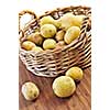 Yellow raw potatoes in a basket close up