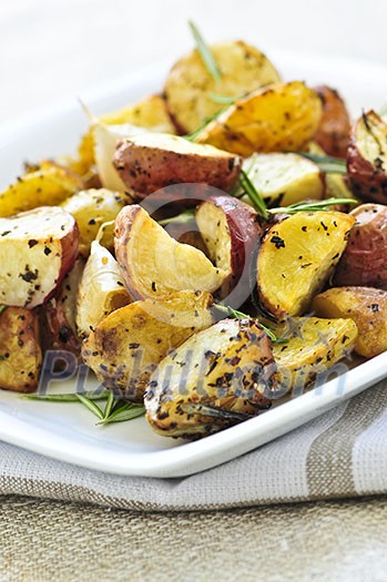 Herb roasted potatoes served on a plate Herb roasted potatoes served on a plate