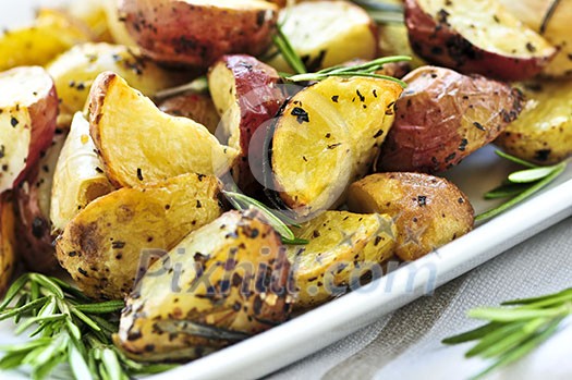 Herb roasted potatoes served on a plate Herb roasted potatoes served on a plate