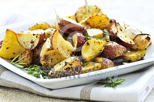 Herb roasted potatoes served on a plate