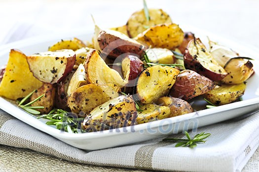 Herb roasted potatoes served on a plate Herb roasted potatoes served on a plate