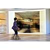 Woman shopping in a mall, panning shot, intentional in-camera motion blur