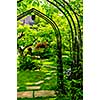 Lush green garden with wrought iron arbor
