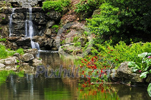 Cascading waterfall and pond in japanese garden Cascading waterfall and pond in japanese garden