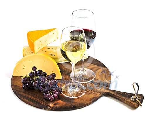 Wineglasses with red and white wine and assorted cheeses Wineglasses with red and white wine and assorted cheeses
