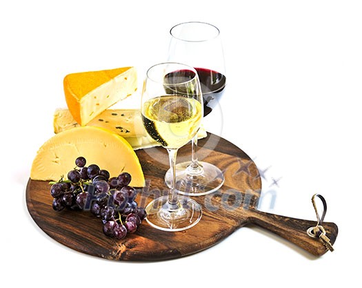 Wineglasses with red and white wine and assorted cheeses