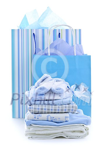 Gift bags and infant clothes for baby shower isolated on white