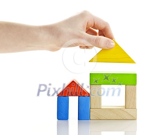 Wooden block houses under construction isolated on white background