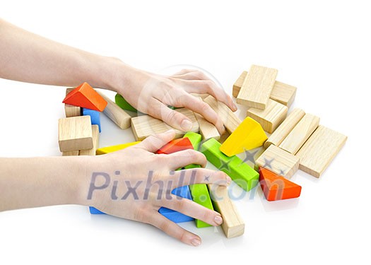 Hands with pile of wooden block toys isolated on white Hands with pile of wooden block toys isolated on white