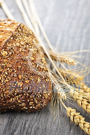Loaf of fresh baked multigrain bread with grain ears