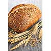 Loaf of fresh baked multigrain bread with grain ears