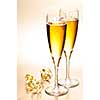 Two full champagne flutes with sparkling wine and ribbon