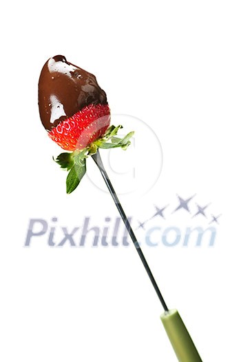 Strawberry dipped in delicious chocolate on fondue skewer