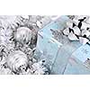 Wrapped gift box with silver Christmas ornaments